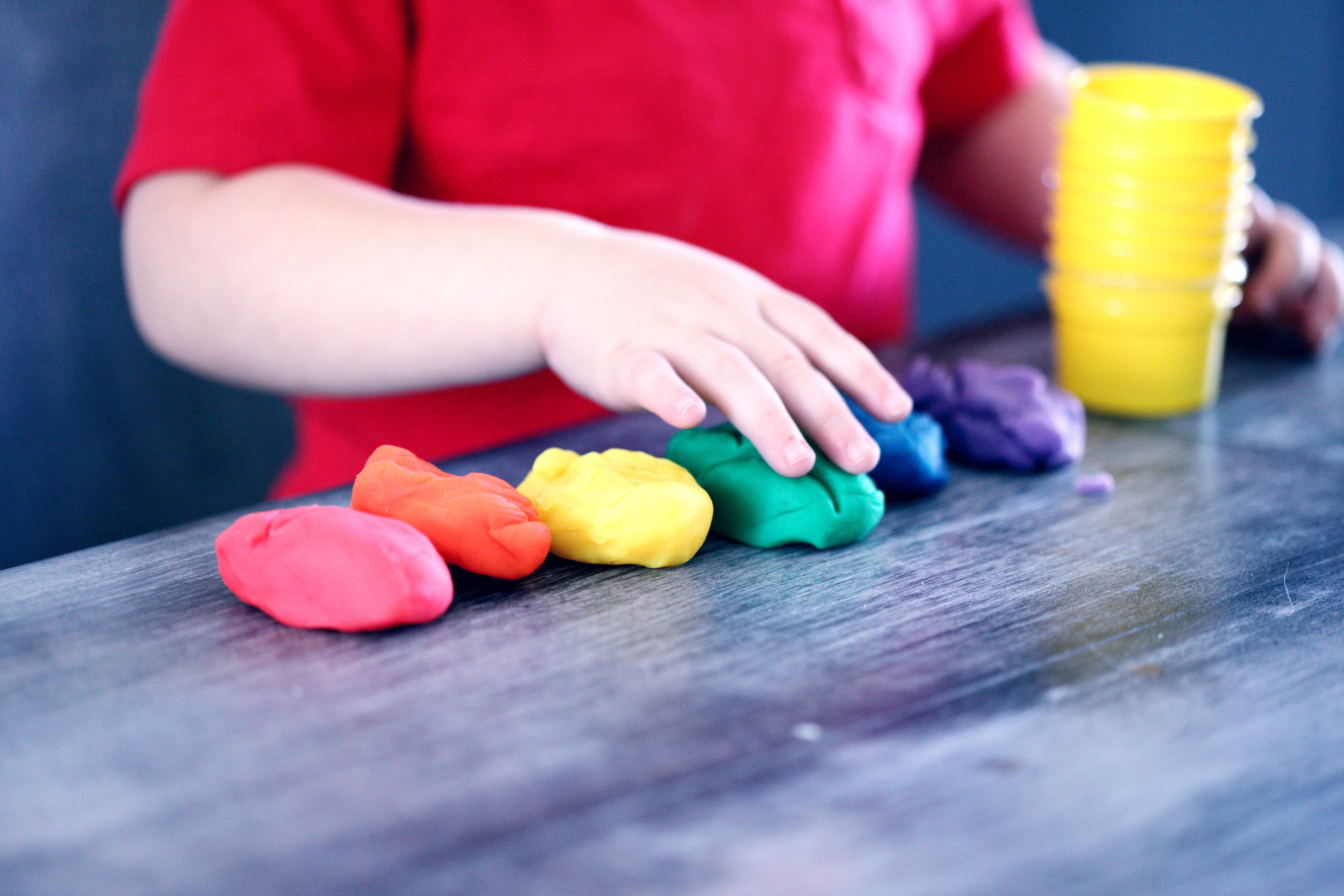 Boy playing with play dough, CBD oil and autism