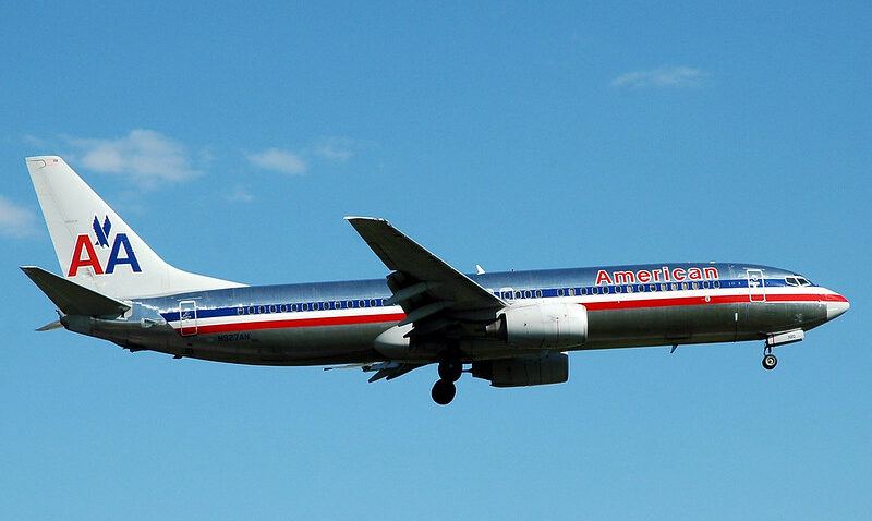American Airlines plane flying, blue sky